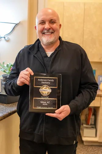 Dr. Anderson holding his award at Anderson Family Dentistry