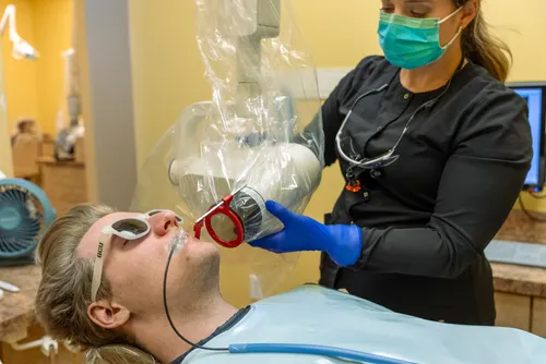 Dental hygienist performing periodontal treatment at Anderson Family Dentistry