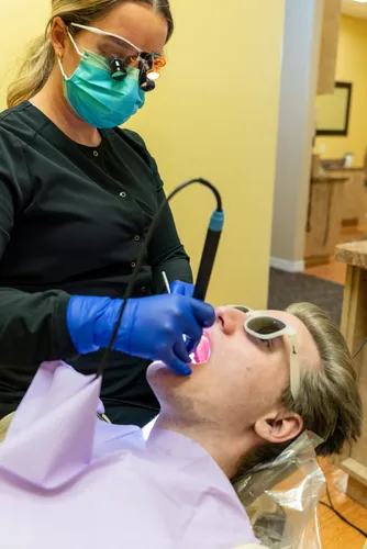 Hygienist using advanced tools during periodontal care